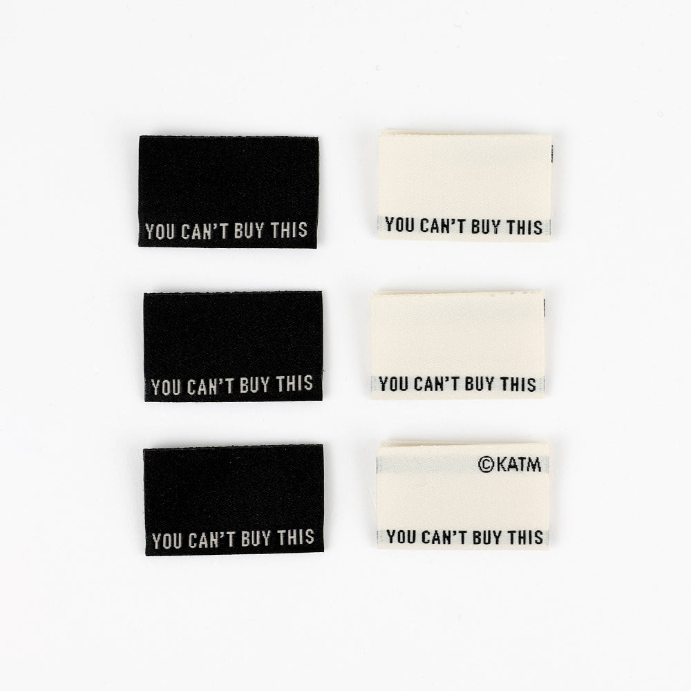 Set of six rectangular stickers with 'You Can't Buy This' text on a white background.