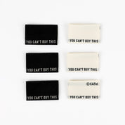 Set of six rectangular stickers with 'You Can't Buy This' text on a white background.